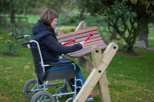 A wheelchair users uses the inclusive play musical instruments