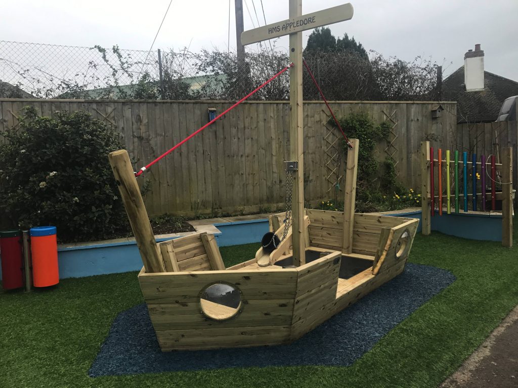 The HMS Appledore wooden play boat installed in a childrens playground
