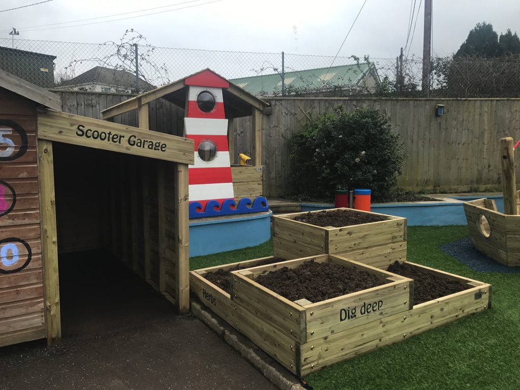 A wooden scooter garage built in to the school play area