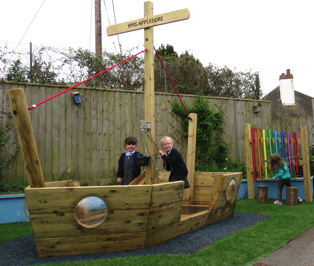 A wooden play boat in the school play area