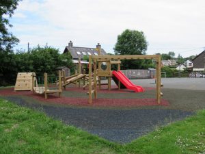 Play equipment installed over safety surfacing