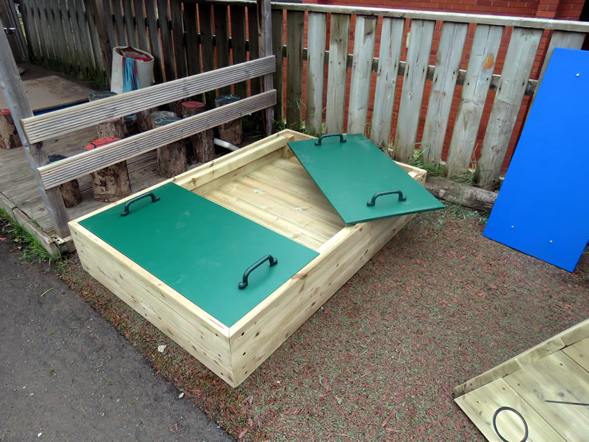 Raised wood framed sand pit with lid