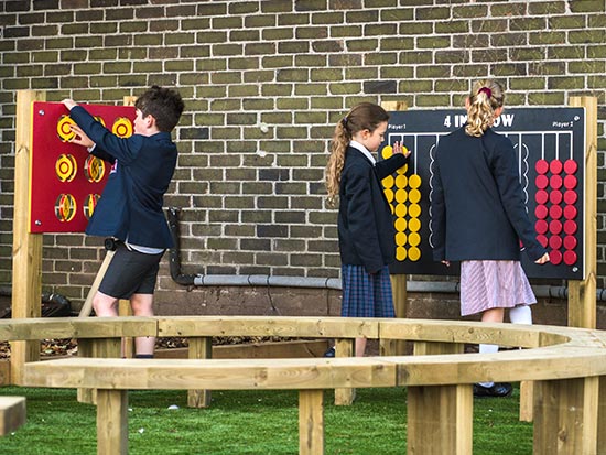 Children playing the 4 in a row playground game