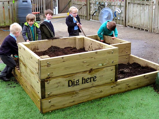 A large wooden planter in a play area