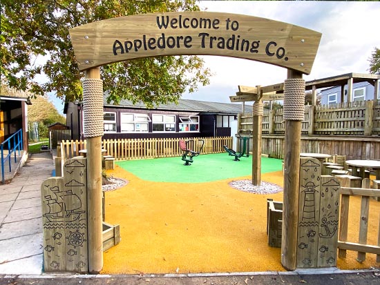 A wooden archway leading to a play area