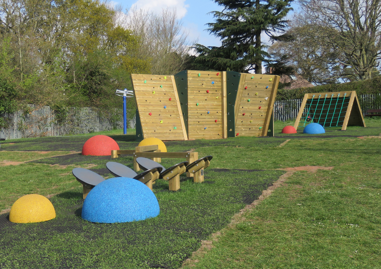 School playground adventure tail showing wooden climbers and a net climber