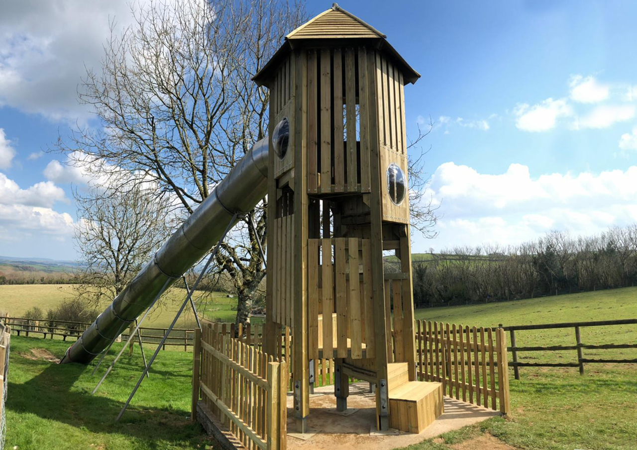 A tall wooden play tower installed at Pennywell farm viewed from behind
