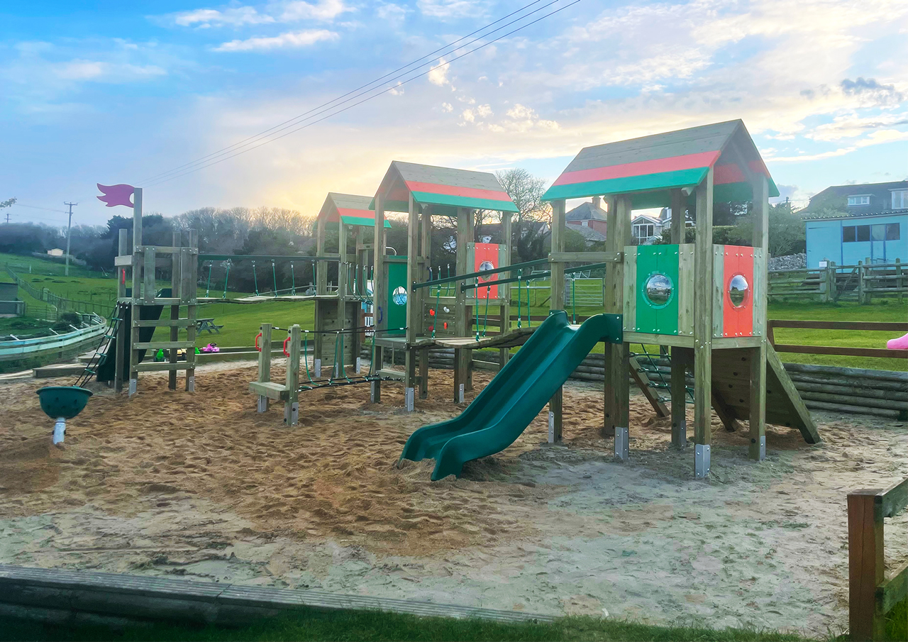 Installation of play equipment of a sand safety surface