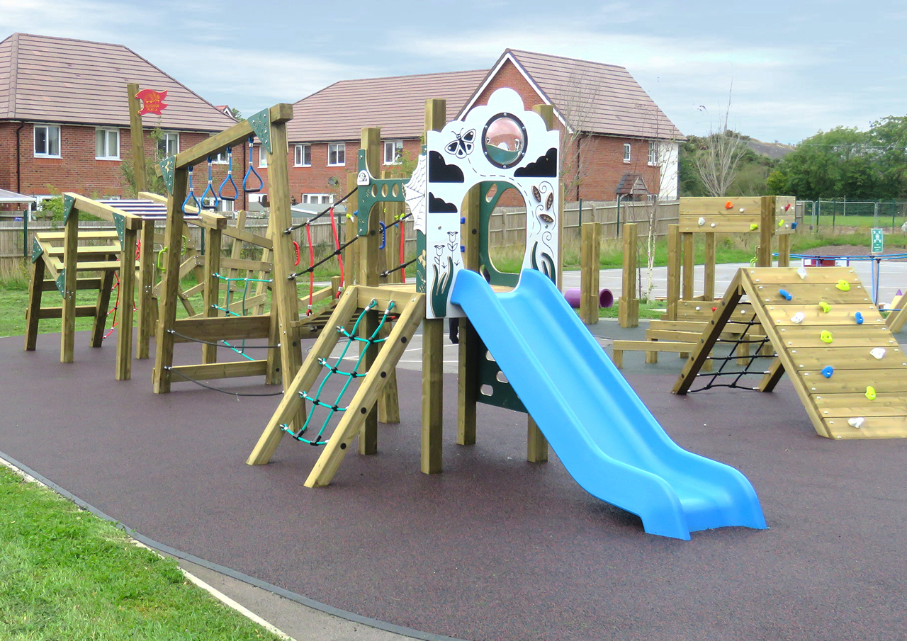 A school playground adventure trail with blue plastic slide