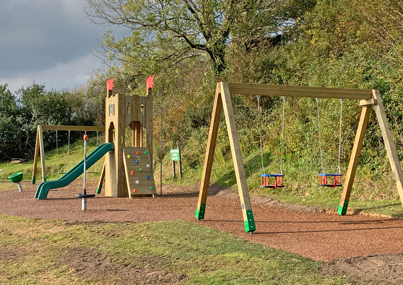 Traditional wooden swings installed in a play area