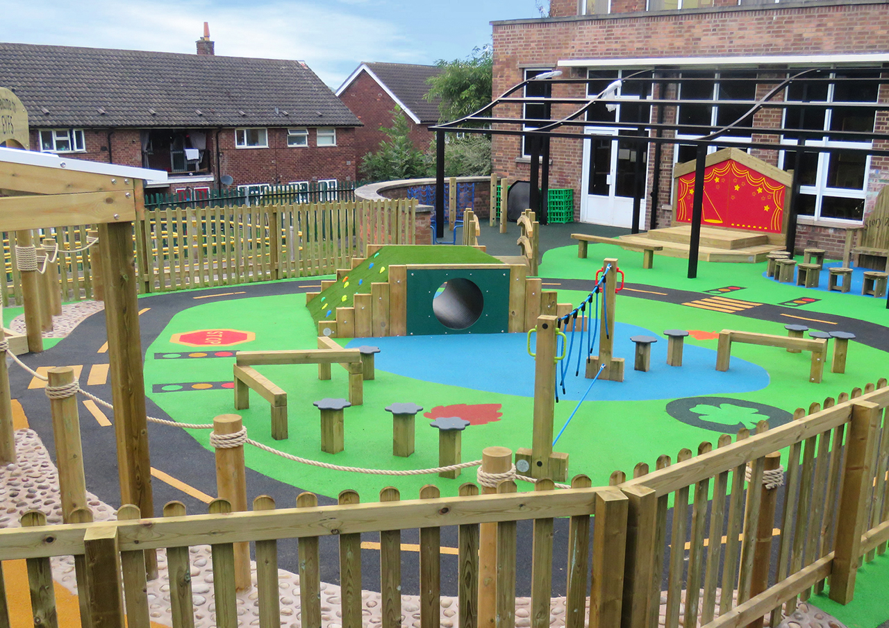A large childrens play area covered in themed safety surfacing
