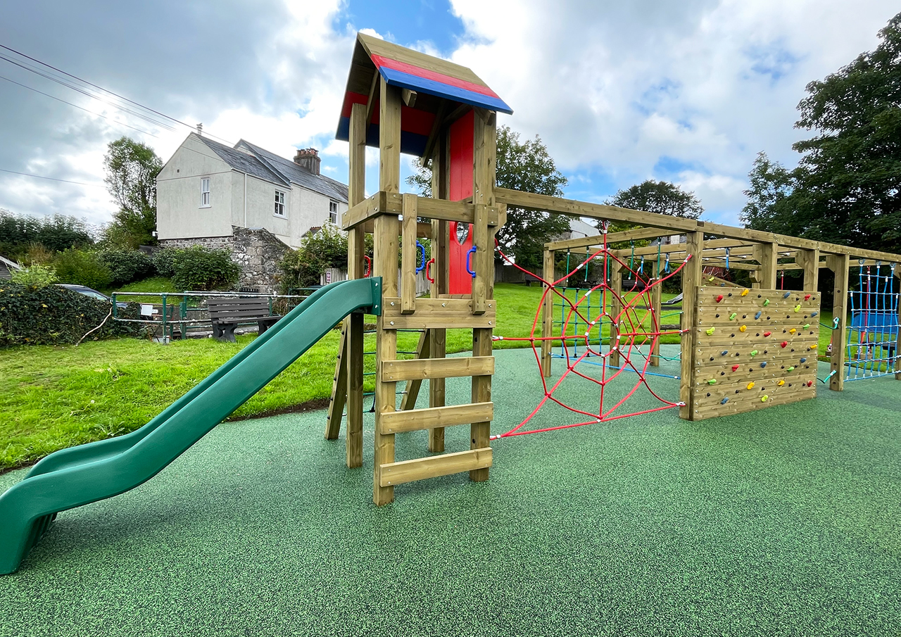 Wooden play towers installed on safety surfacing at Cornwood in Devon