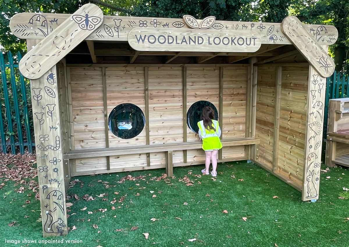 A child looking through the woodland lookout window